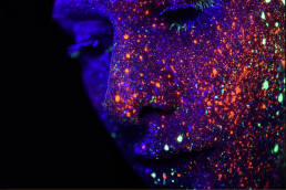 Coloured face with fluorescent dots